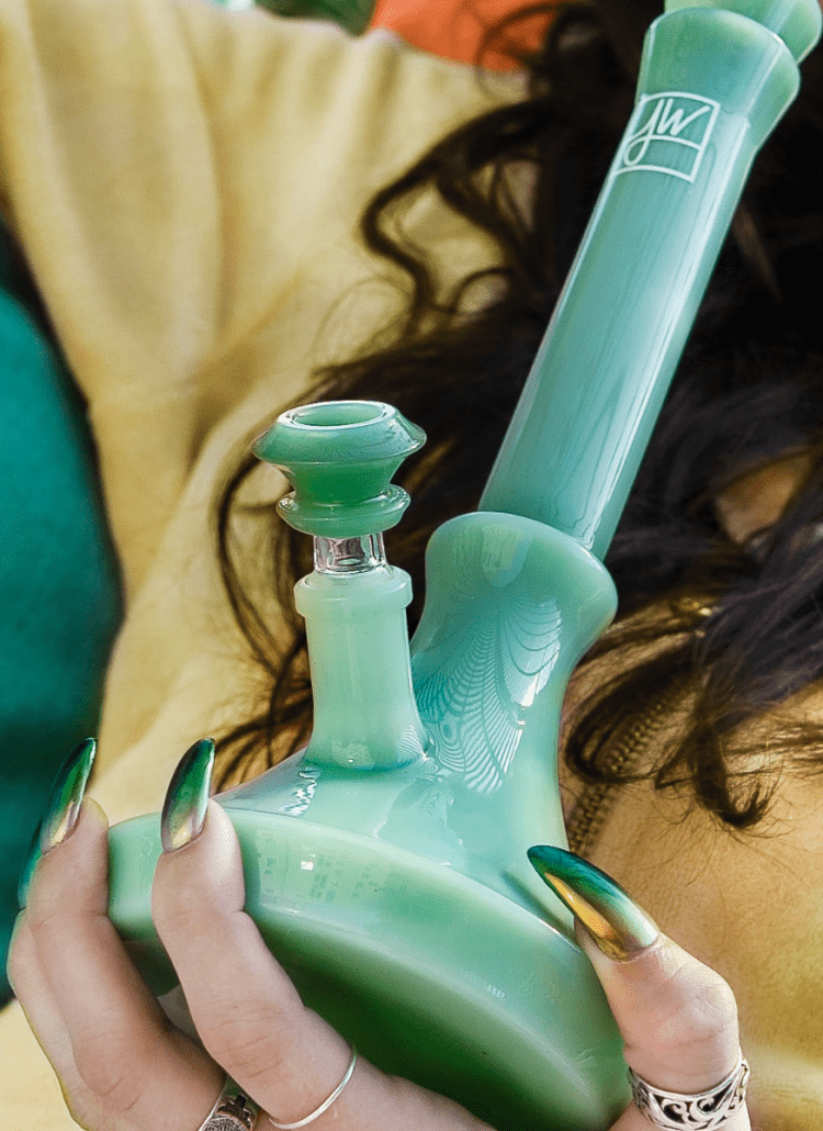 woman smoking cannabis out of jane west glass water pipe bong